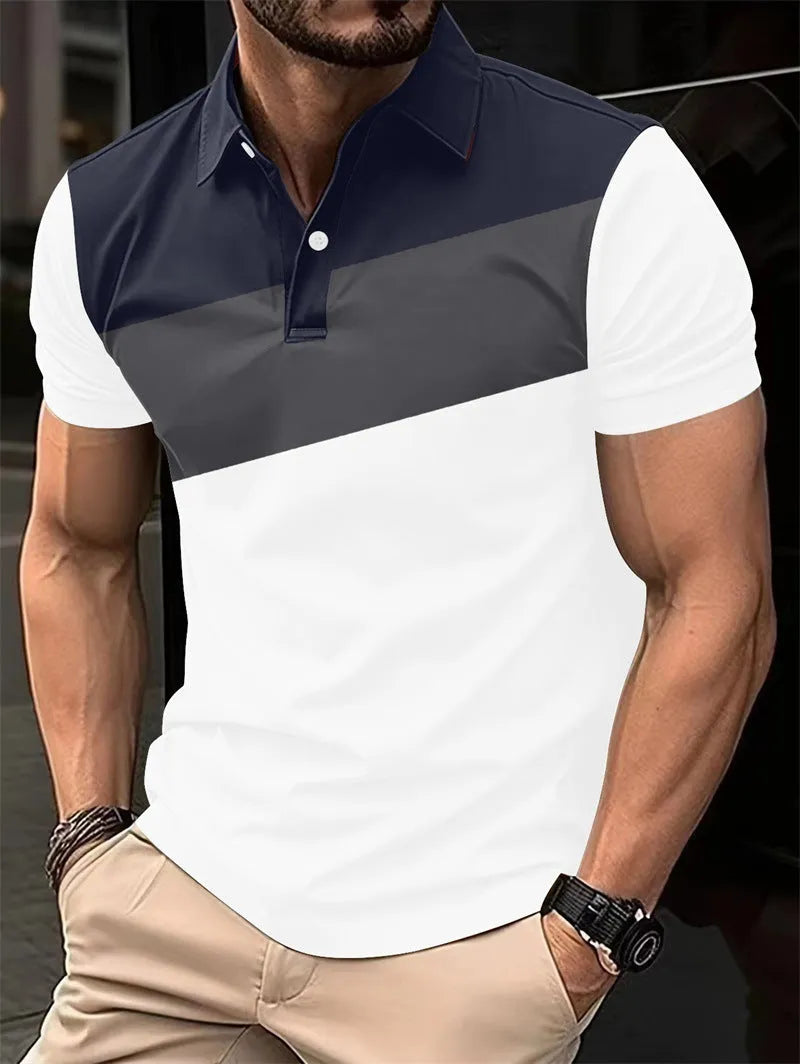 Man wearing a loose-fit grey T-shirt with a colourful 3D digital print pattern on the front.