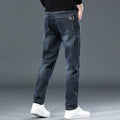 Blue grey slim straight casual trousers on a hanger, showing mid waist and straight leg design.