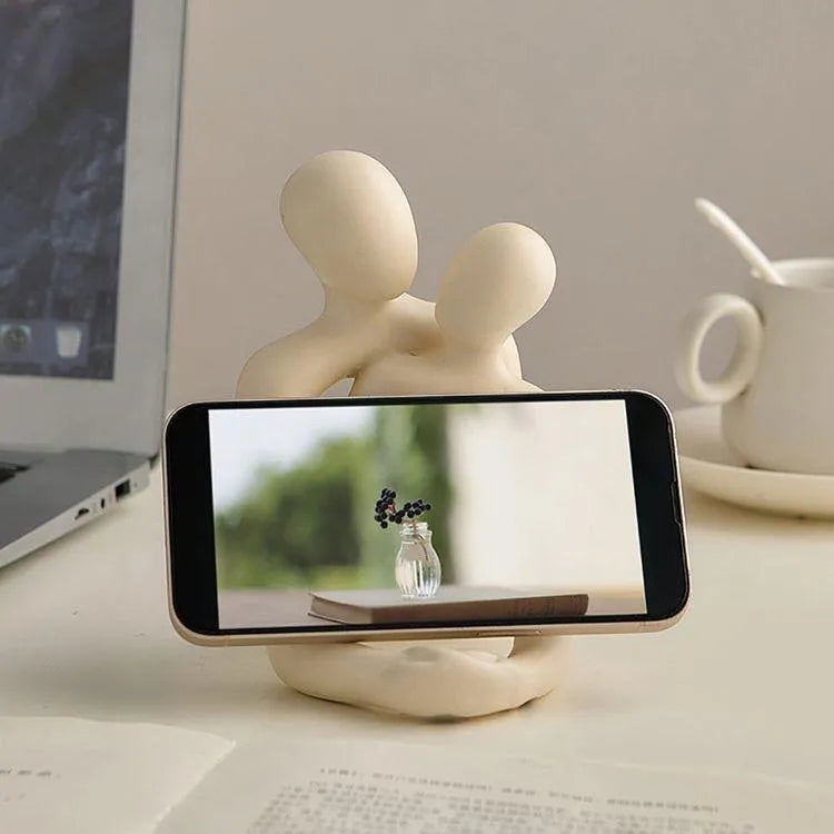 A milky white resin statue of a loving couple, modern decorative accent for shelves or desks.