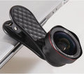 Black mobile phone wide-angle and macro lens kit with mounting clip and storage box on a table