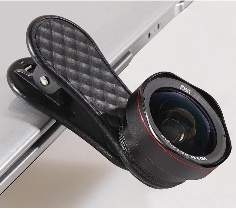Black mobile phone wide-angle and macro lens kit with mounting clip and storage box on a table
