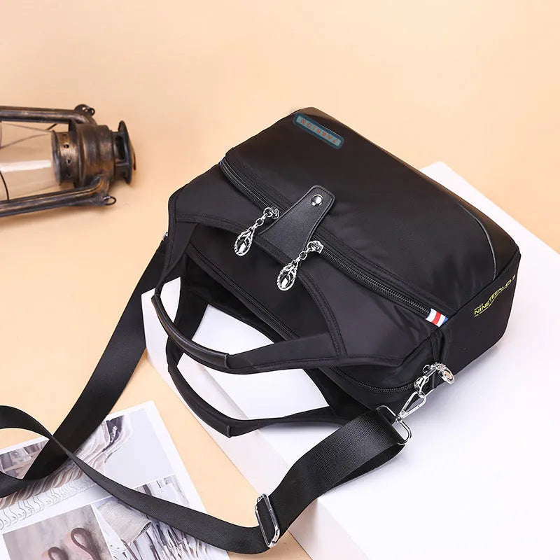 Women's crossbody bag in Oxford cloth with zippered closure and adjustable shoulder strap, 29cm long, available in multiple colours