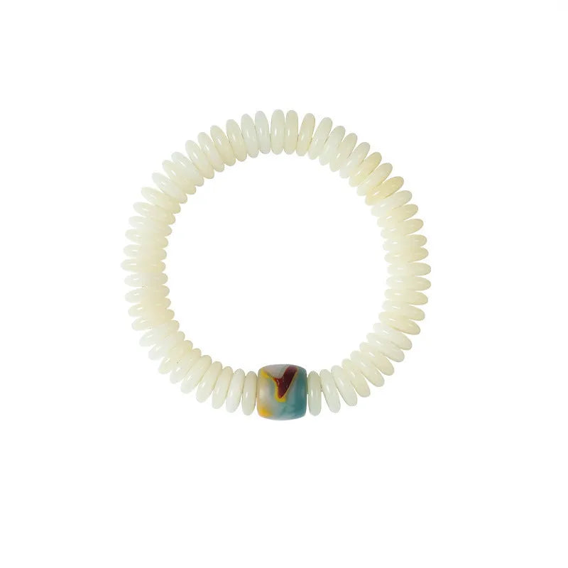Close-up of a White Bodhi seed bracelet or handheld strand showing 3x10mm natural beads.