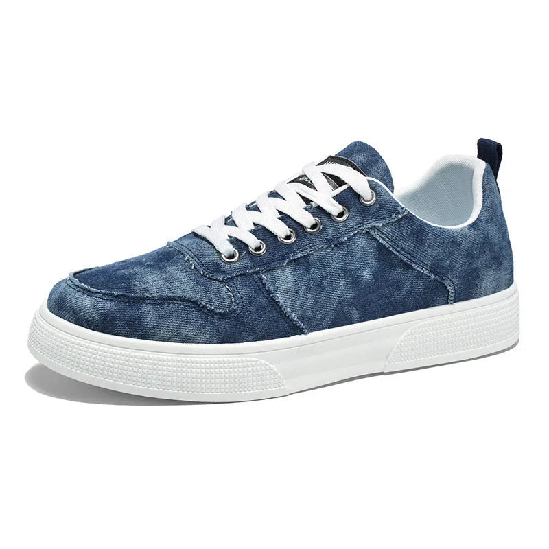 Men's low-top blue canvas sneakers with white platform sole and lace-up front.