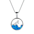 Close-up of a geometric pendant fishtail necklace with a round blue opal stone and white gold electroplated finish.