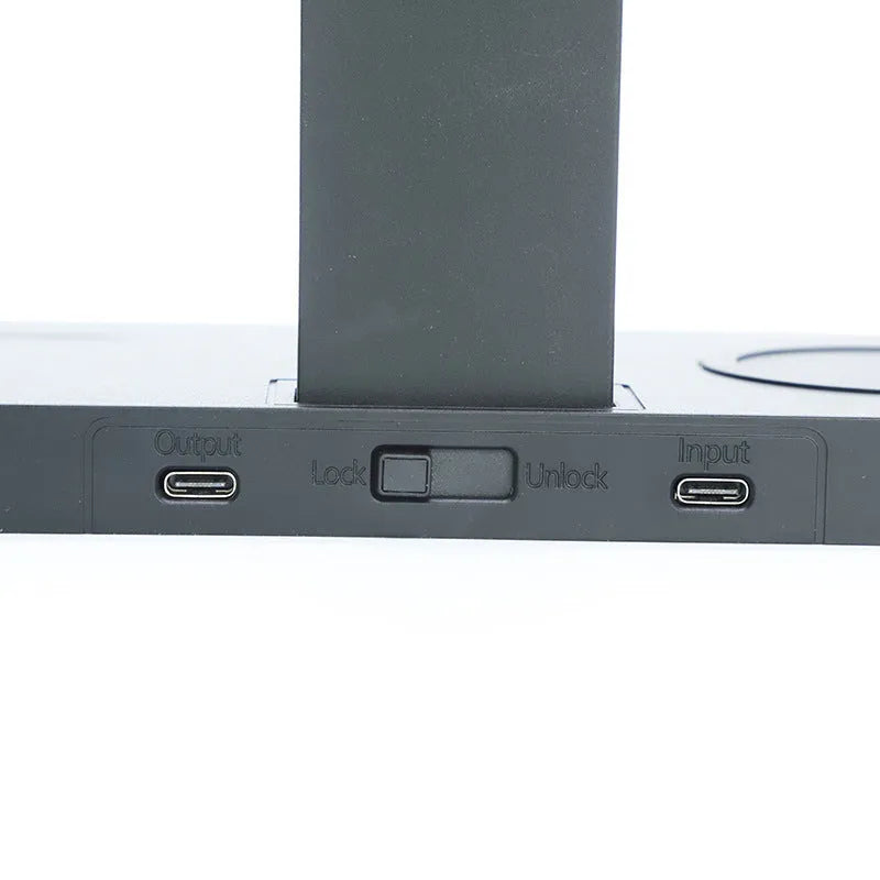 Black multi-device wireless charging station with smartphone, smartwatch, and headset connected