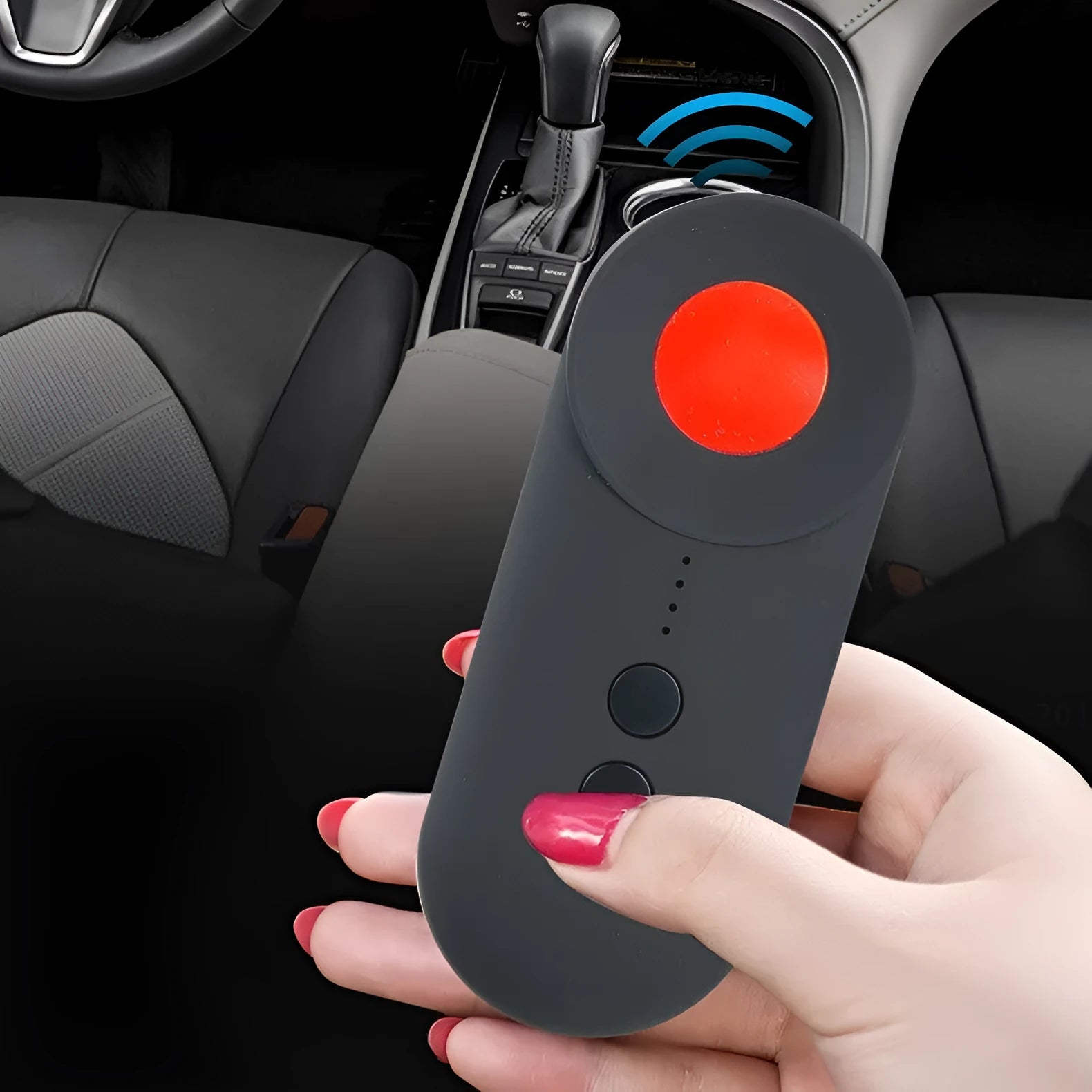 Black portable anti-car GPS and wifi signal detector with a USB cable on a table.