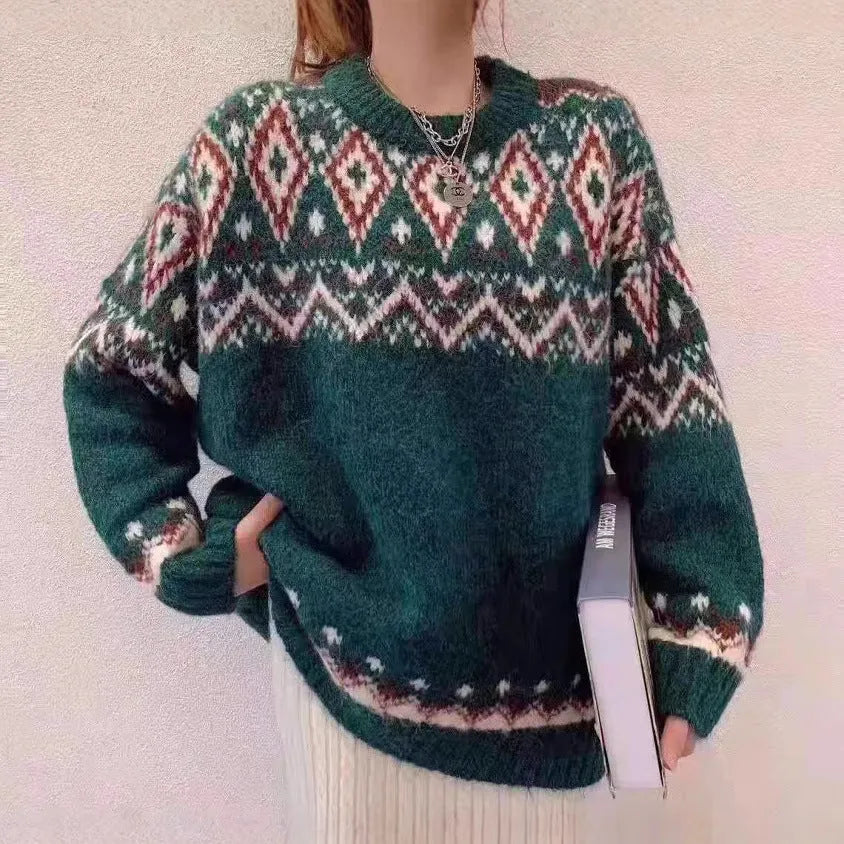 Loose red and white striped retro pullover knitted top with long sleeves on a hanger.