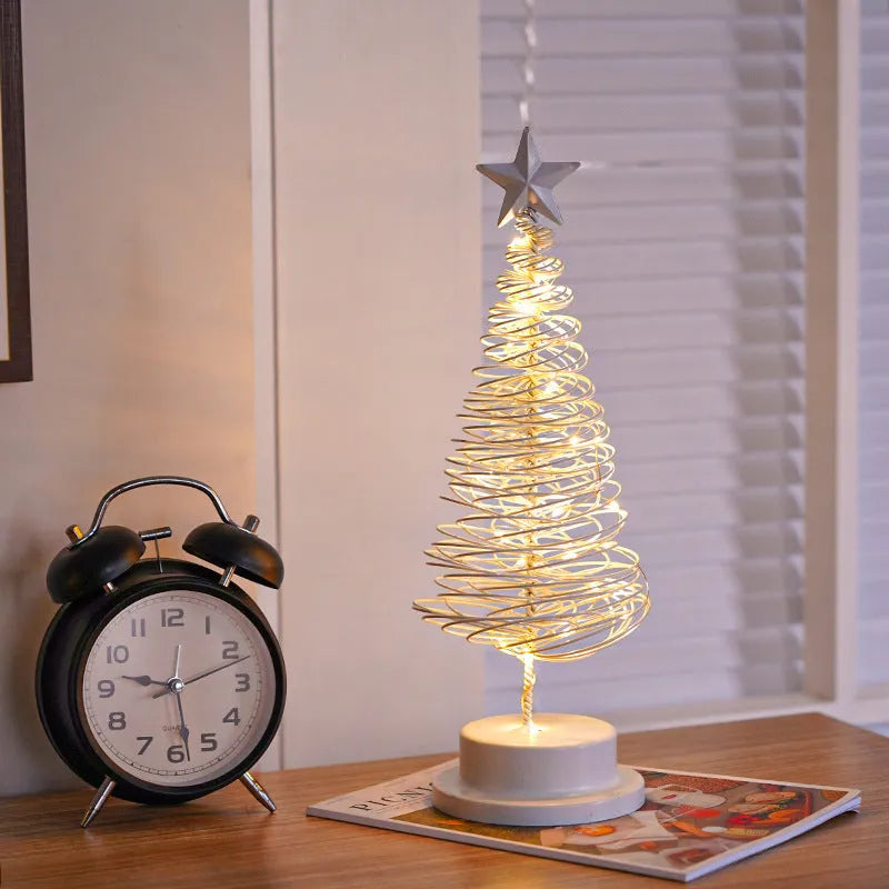 33cm wrought iron Christmas tree spiral light ornament with warm white LED illumination on table