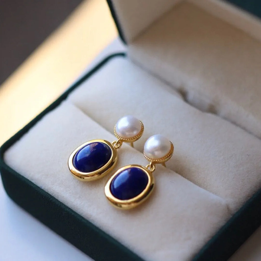A pair of sterling silver drop earrings with a blue lapis lazuli pearl and auspicious patterns.