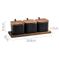 Ceramic seasoning jar set with matte glaze and natural log accents in black, blue, and white