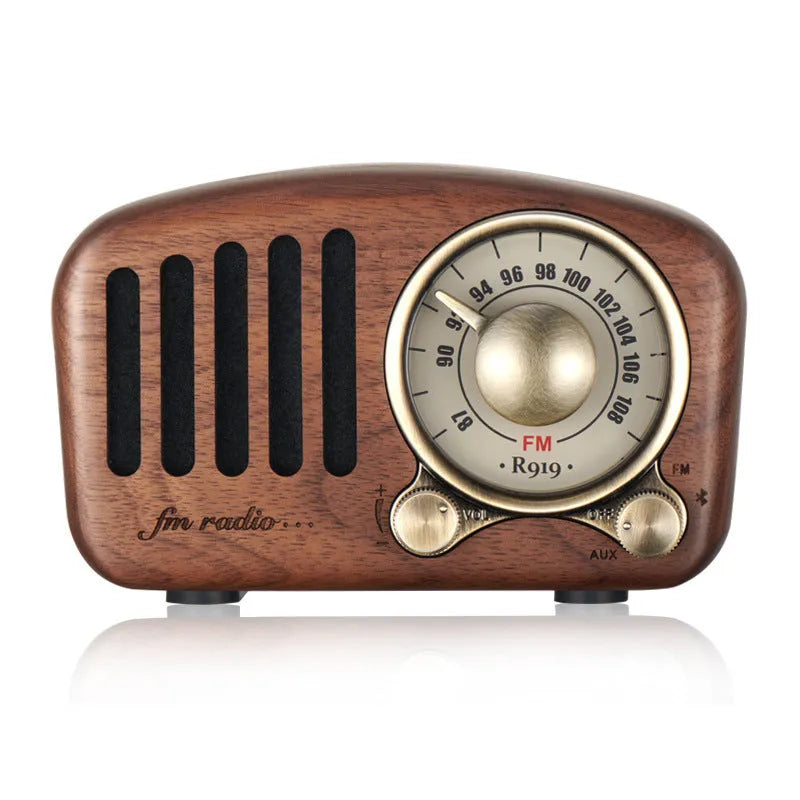 Retro wooden wireless mini speaker in cherry wood finish showing compact size.