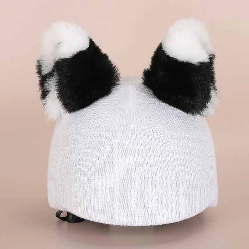 Soft plush fabric cartoon character decoration fitting on the peak of a black ski helmet.