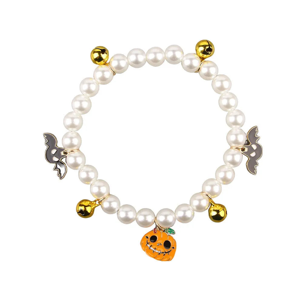 Halloween cat collar with simulated pearls and a choice of purple ghost, skull, or smiling pumpkin print.