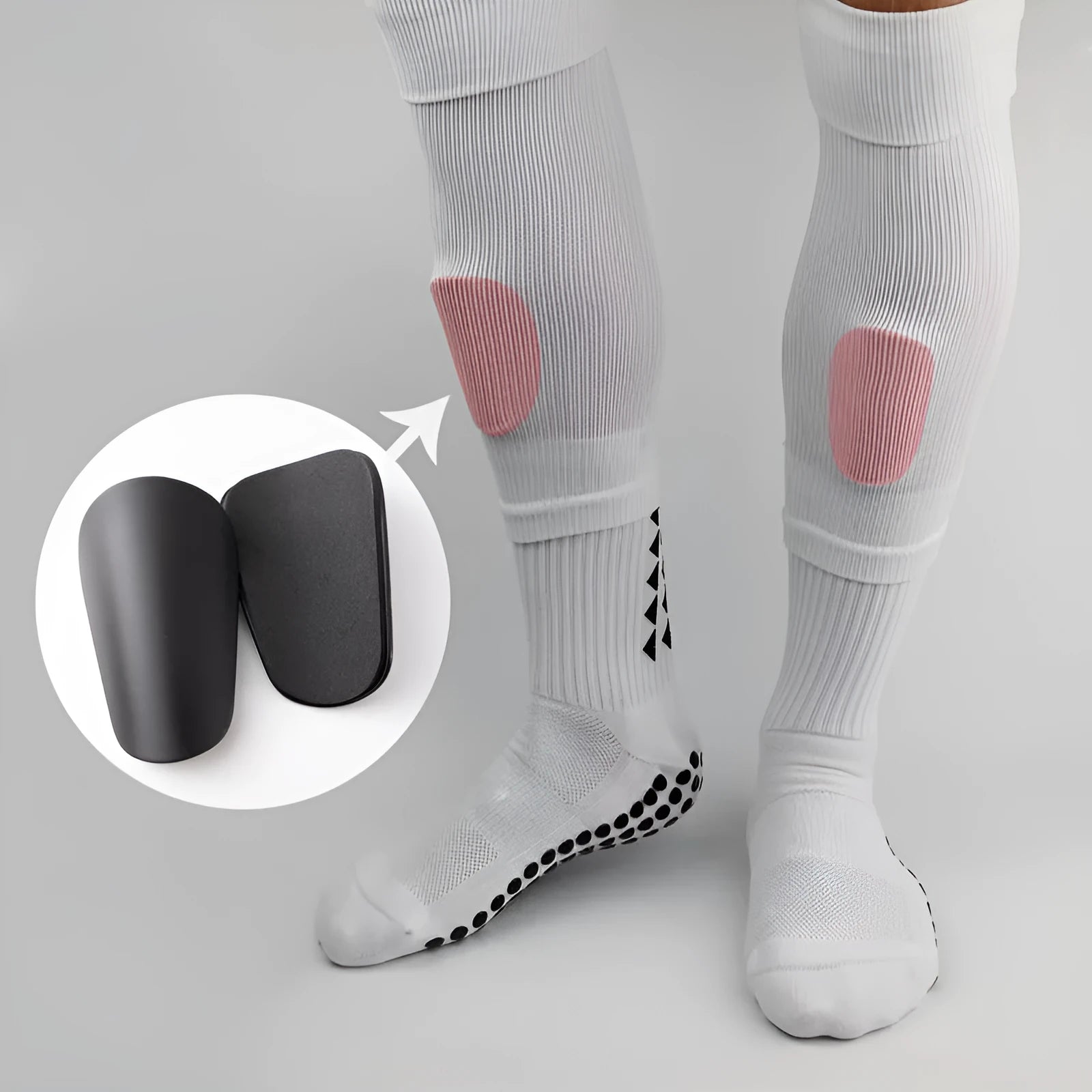 Pair of PU mini shin guards in black, shown on a leg, for football and sports protection.