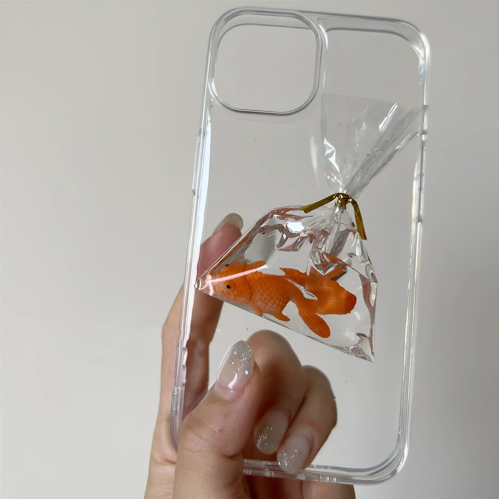 Transparent 3D fish water bag phone case for iPhone showing cartoon fish design