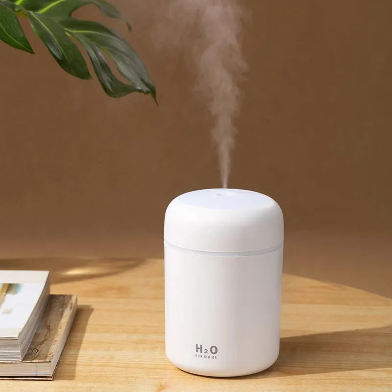 Pink USB desktop humidifier with colourful lights and water mist output