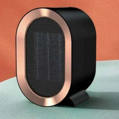 Compact black desktop ceramic heater with mechanical dial controls showing UK plug configuration