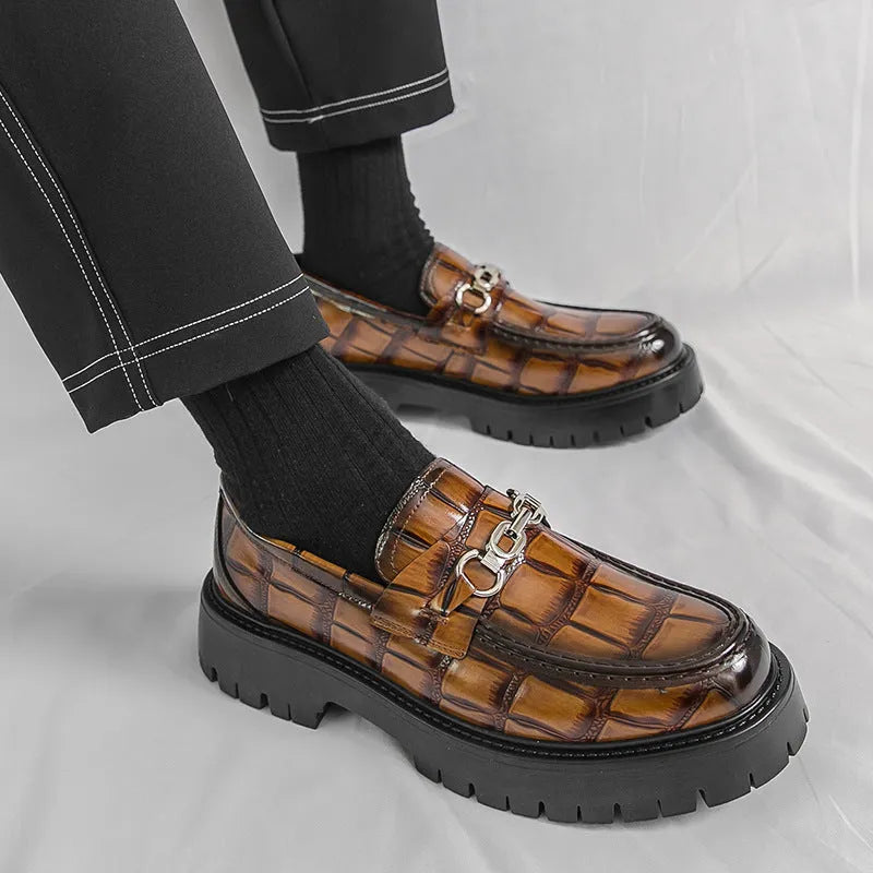 Men's black crocodile pattern leather loafers with a platform sole and flat heel.