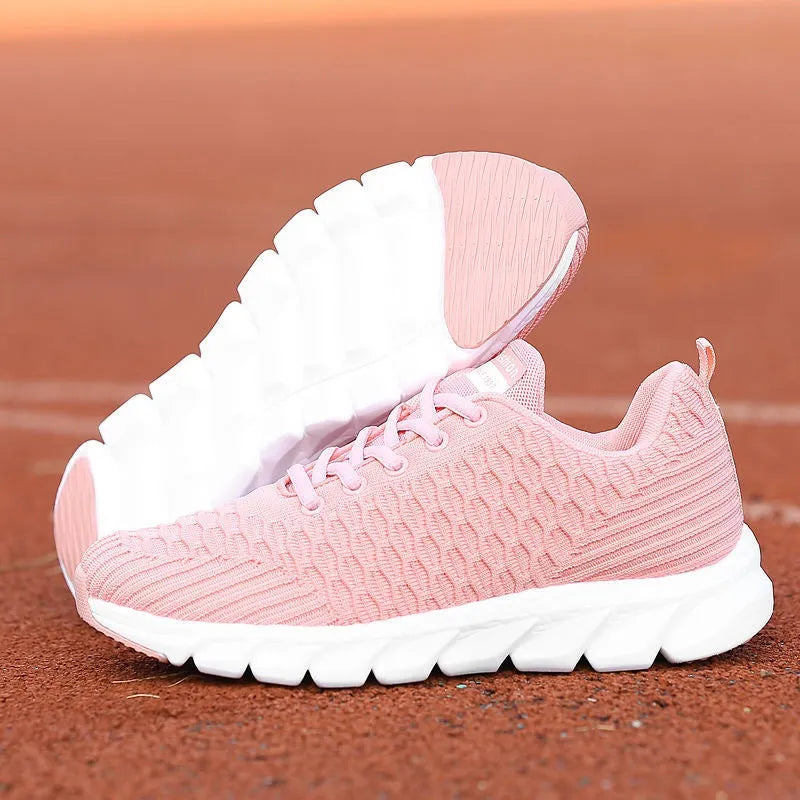 Women's running shoes in black, pink, or white with fly weave upper and wear-resistant outsole