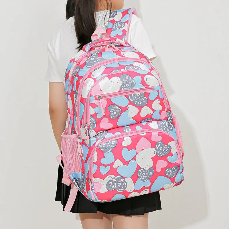 Blue student backpack with air cushion straps on a grey background, showing large main compartment.