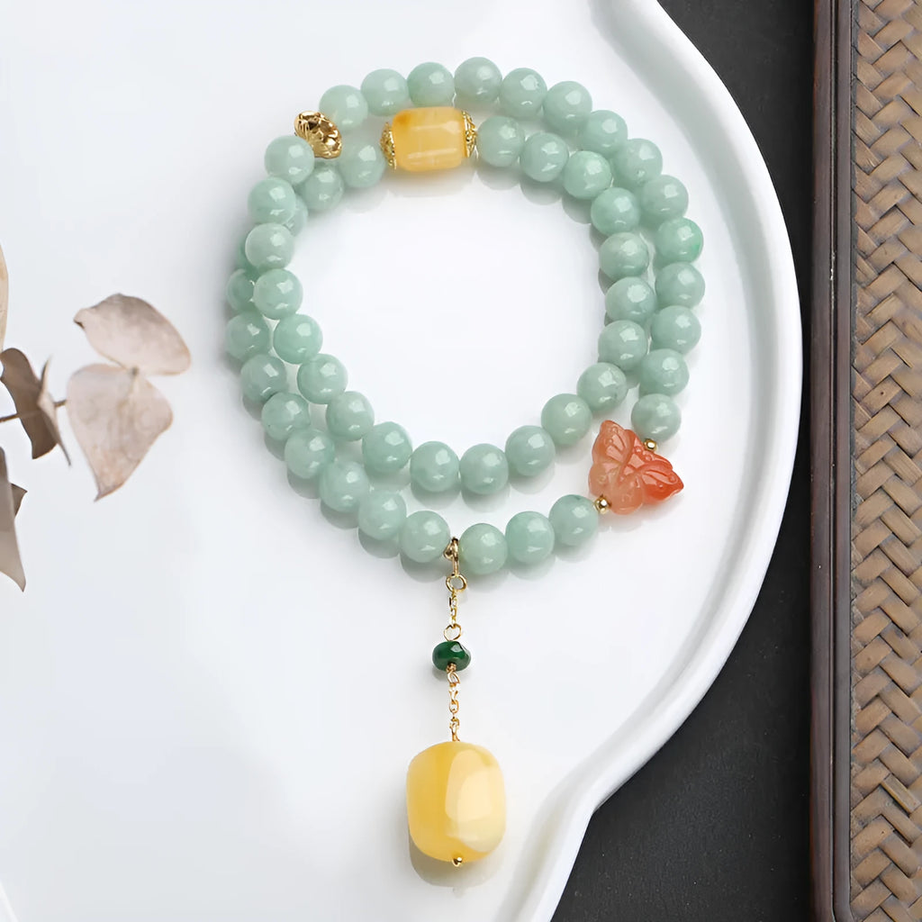 Close-up of a double-layer women's bracelet with green jade round beads and honey-coloured beeswax barrel beads.