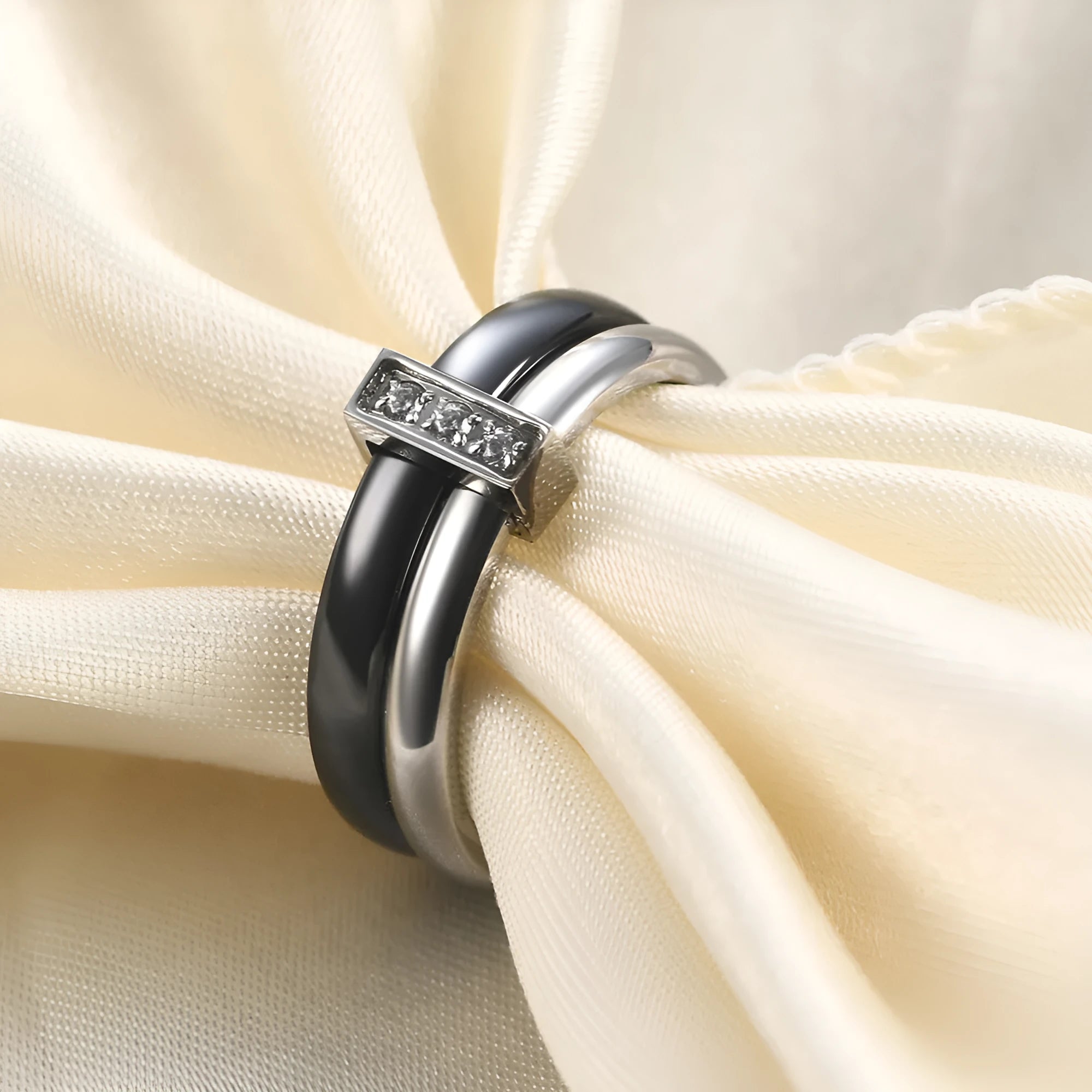 Geometric glossy ceramic women's ring with zirconium inlay, shown in steel black and gold white.