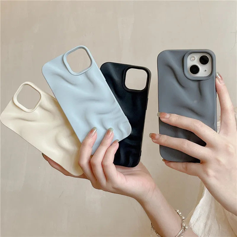 Three-dimensional pleated water ripple TPU phone case for iPhone 14 in glossy silver, showing textured back and edge coverage
