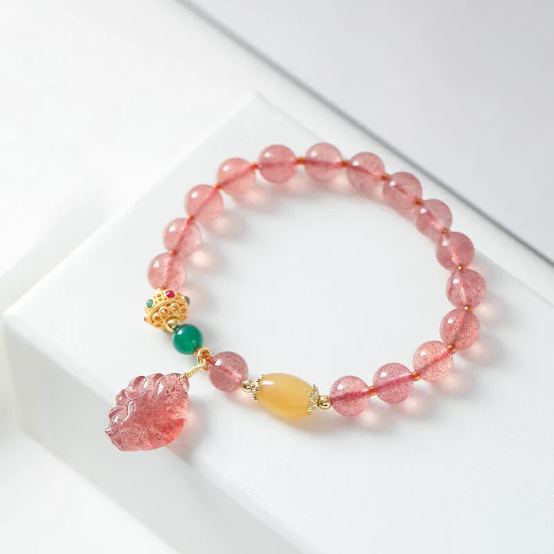 Close-up of a women's crystal beaded bracelet with a nine tail fox charm on a model's wrist.