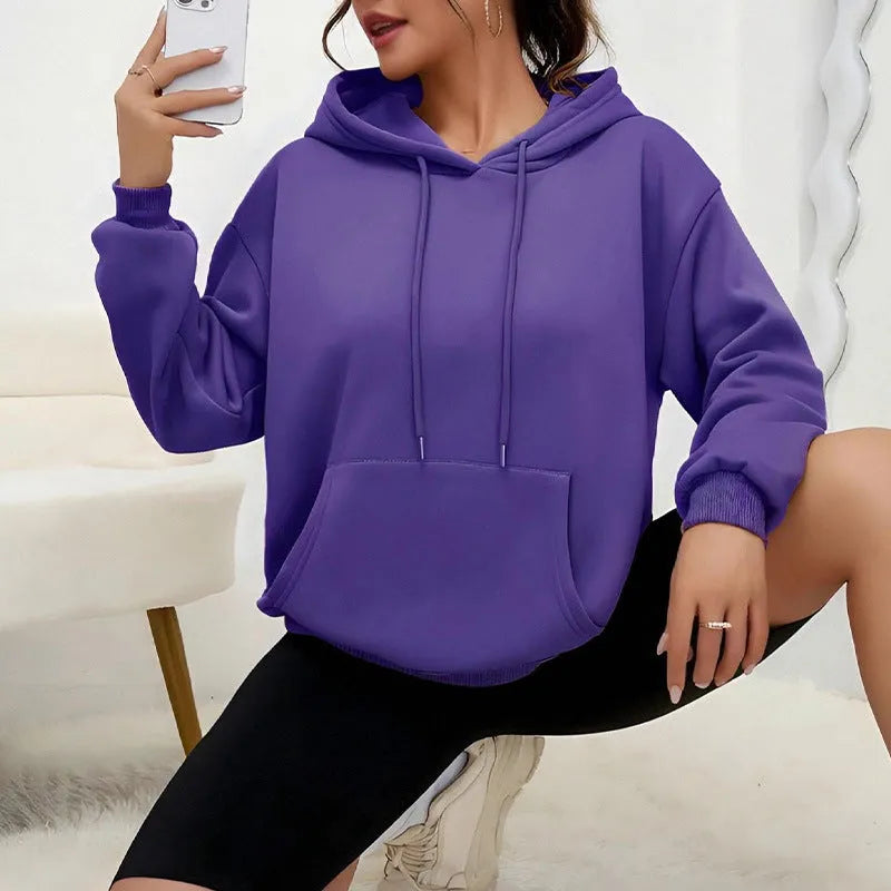 Women's loose grey sweatshirt with a drawstring hem and side pockets, laid flat.