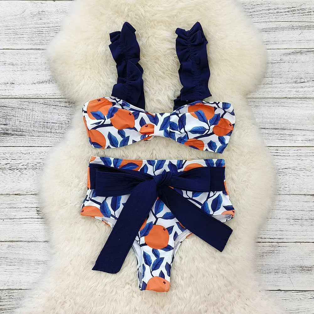 Blue and orange leaf print women's high waist bikini swimsuit on a mannequin.