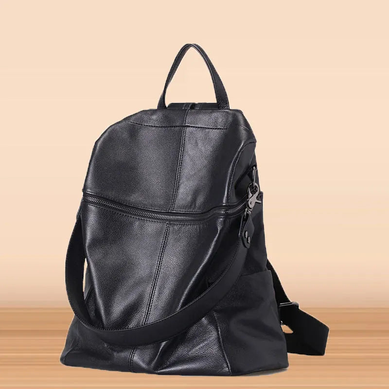 Genuine leather retro-style women's backpack showing front sandwich pocket and brown leather texture.