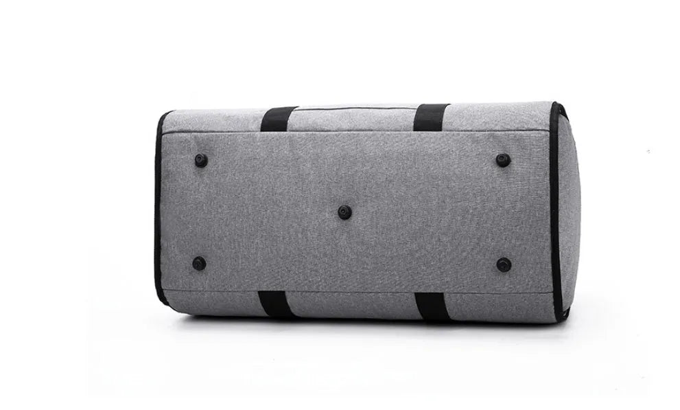 Medium sized cylinder travel bag in black Oxford cloth, showing zipper opening and internal pocket.