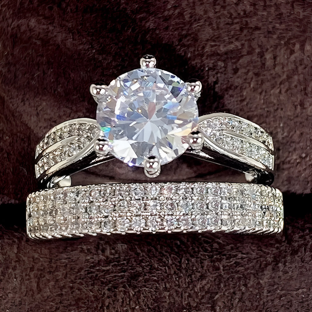 A geometric white gold-coloured alloy wedding ring bracelet on a finger, showing its continuous band design with a round detail.
