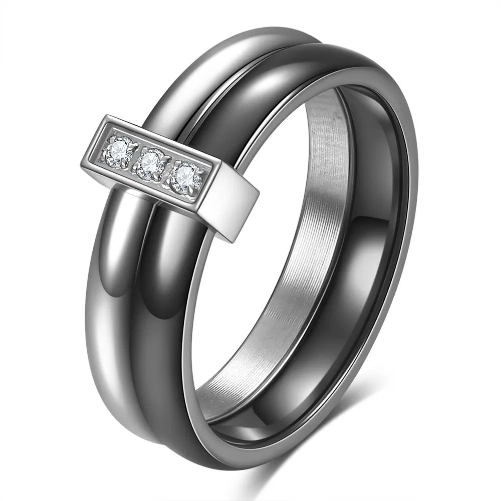 Geometric glossy ceramic women's ring with zirconium inlay, shown in steel black and gold white.