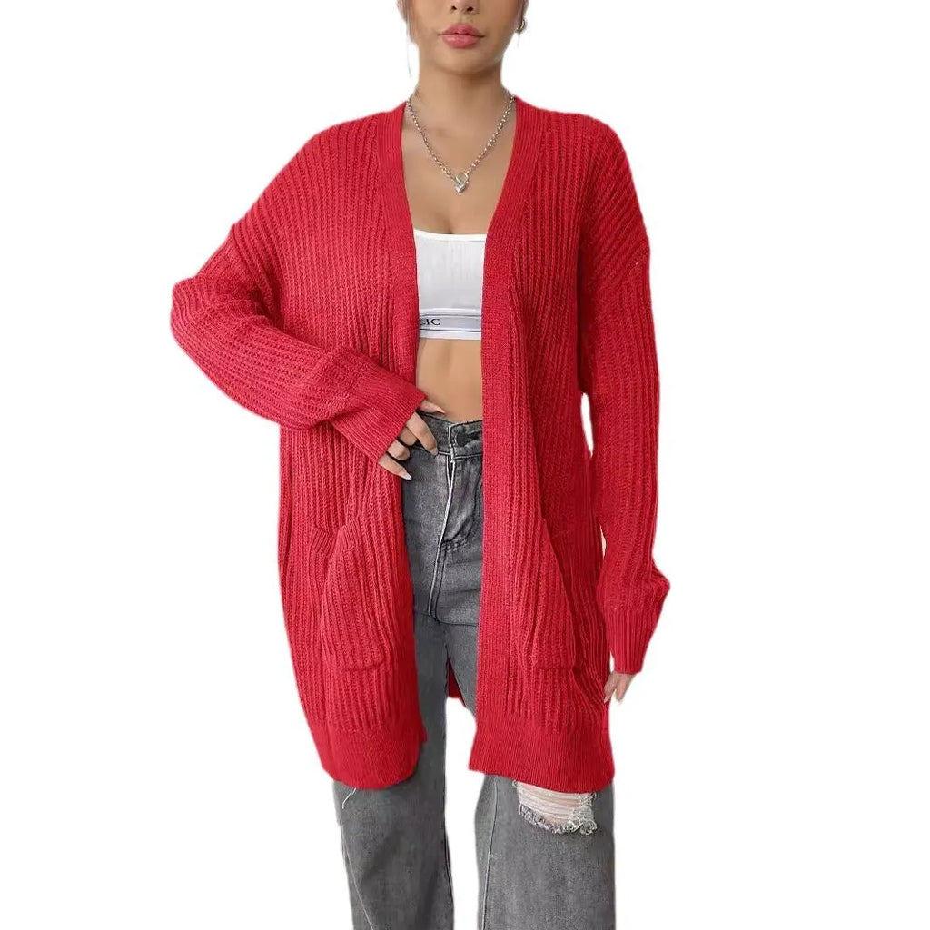 A dark green loose-fit sweater cardigan with two front pockets and long sleeves.