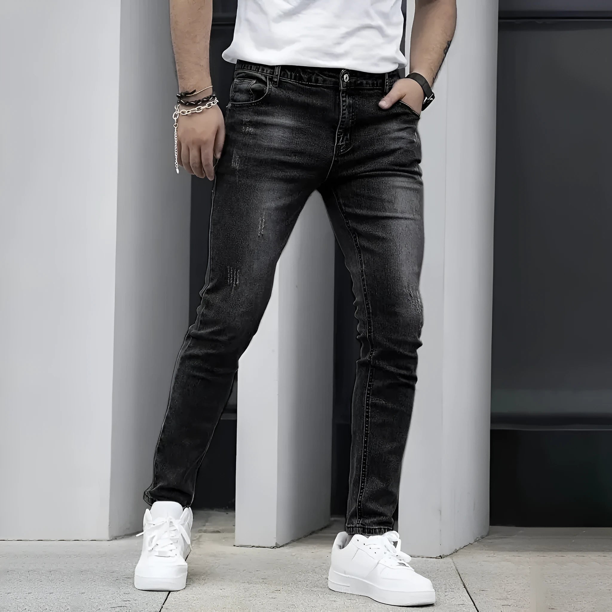 A pair of men's solid colour stretch jeans in a straight leg skinny fit, shown in dark blue.