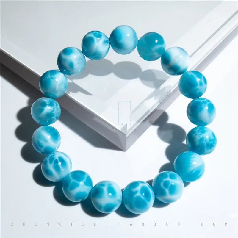 Blue handcrafted Bodhi bracelet with pearl accents, showing different bead size options.