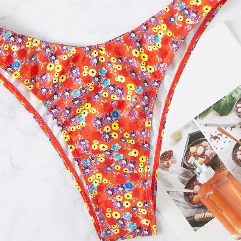 Red women's swimsuit with small floral pattern, high waist design, and side splits on legs