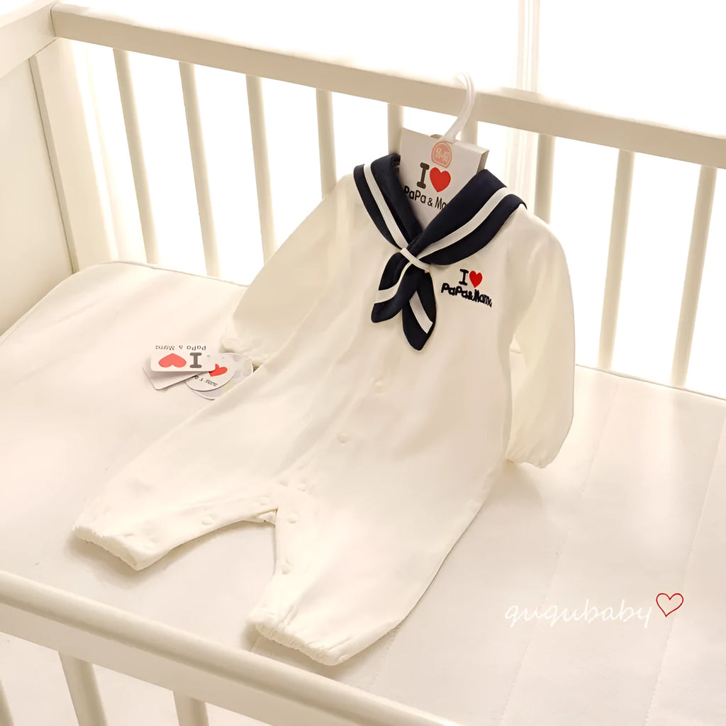 Navy blue Japanese style baby bodysuit with long sleeves and a detachable hood laid flat.
