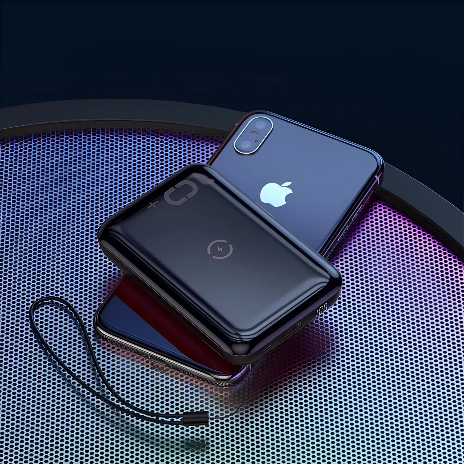 Small square black portable power bank with LED digital display on a table.