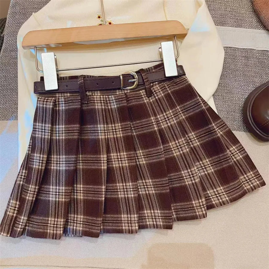 Children's plaid patterned pleated A-line skirt in cotton blend fabric.