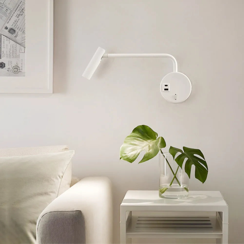 Black minimalist rocker reading wall lamp with LED light on a white wall