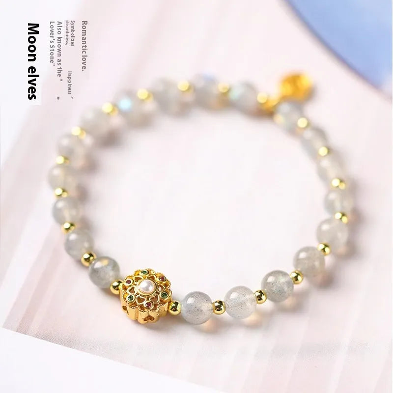 Hand-woven crystal bracelet with gray moonstone, sunstone, and strawberry quartz beads in pastoral style.