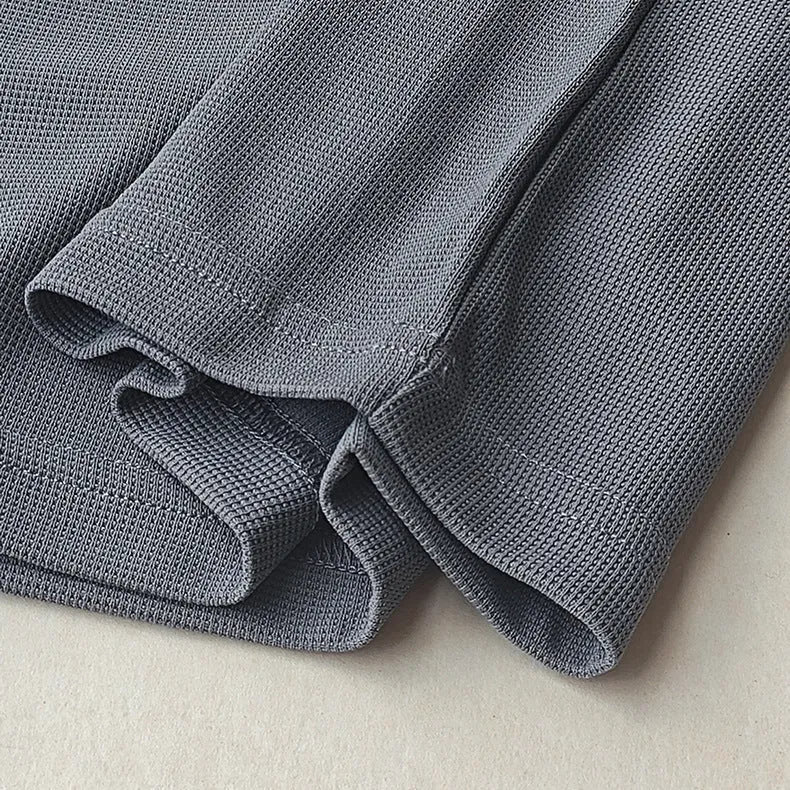 Men's dark grey heavyweight waffle knit short-sleeved T-shirt on a hanger.