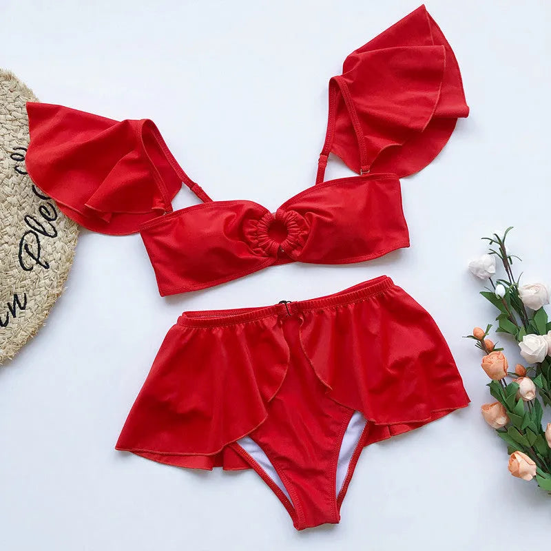 Women's red flounced bikini swimsuit three-piece set on white background