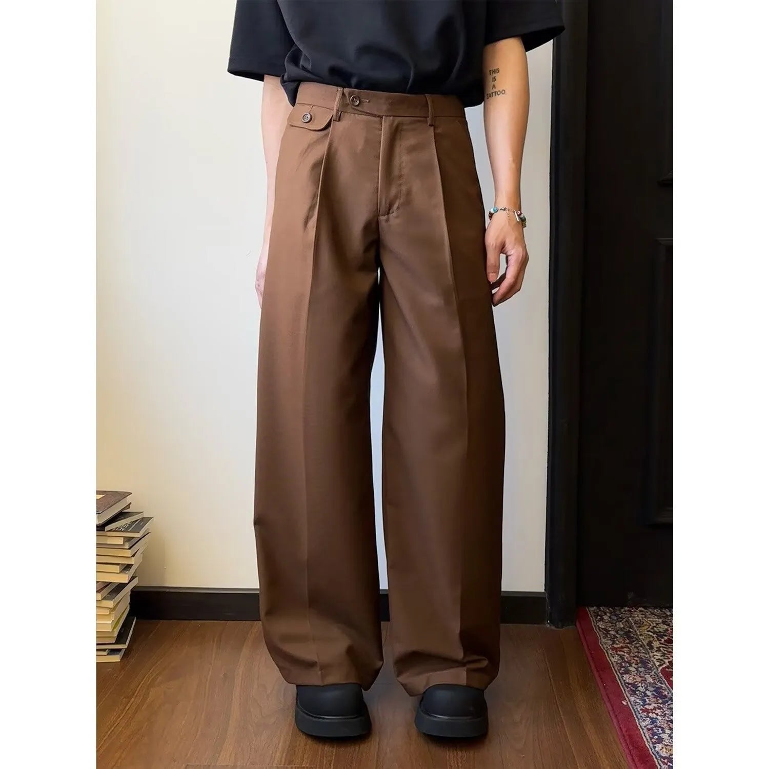 Man wearing brown straight wide-leg casual suit trousers made from a polyester blend fabric.