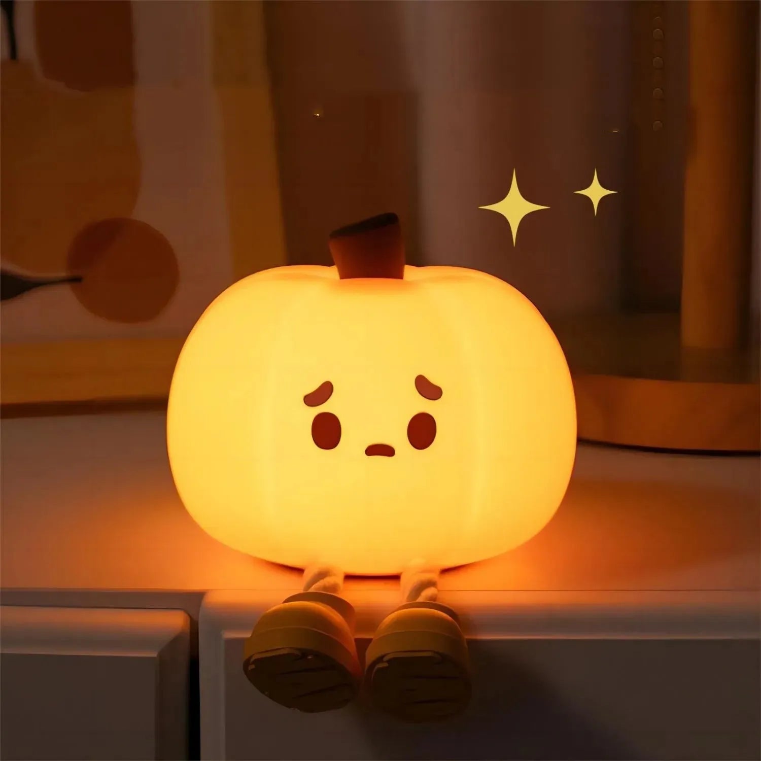 Soft orange silicone pumpkin-shaped night light with a warm glowing light.