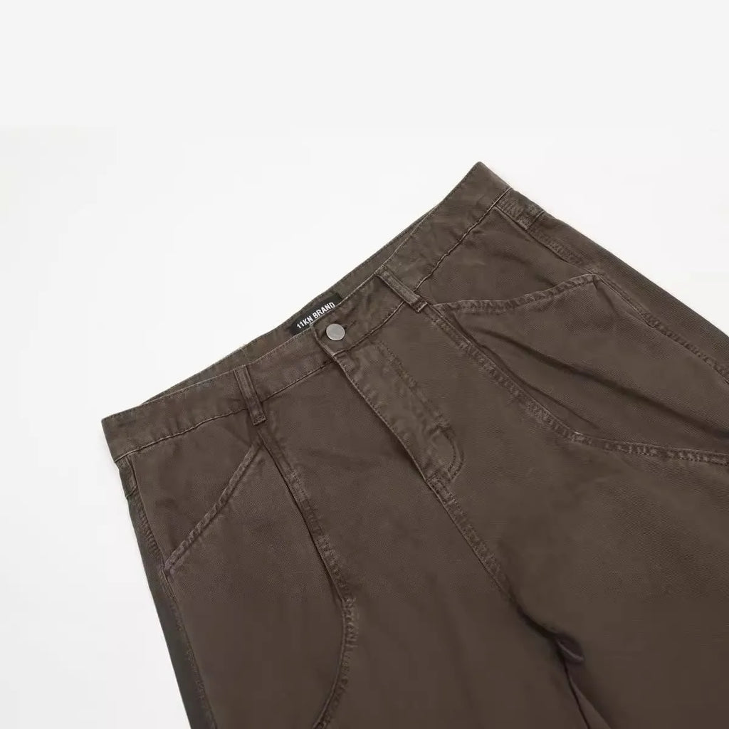 Men's brown loose-fit high-waisted straight-leg cotton trousers on a hanger.