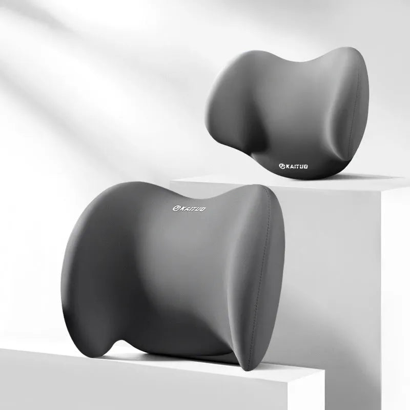 Grey geometric-patterned memory foam car headrest pillow and lumbar support pillow on a car seat.